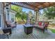 Outdoor patio features a pergola, comfortable seating, and a cozy fire pit at 2742 S Braun Way, Lakewood, CO 80228