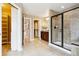 Spacious bathroom with walk-in closets, tile flooring, dual vanities, and glass shower at 6043 S Paris St, Greenwood Village, CO 80111