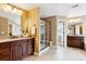 Elegant bathroom features dual sinks, granite countertops, and a glass-enclosed shower at 6043 S Paris St, Greenwood Village, CO 80111