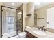 Elegant bathroom with granite vanity, glass enclosed shower with tiled surround, and bright lighting at 6043 S Paris St, Greenwood Village, CO 80111