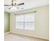 Neutral bedroom showcases a ceiling fan, window with blinds, and plush carpeting at 6043 S Paris St, Greenwood Village, CO 80111