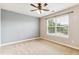 Bedroom with a view of the outside featuring plush carpet, light walls and large window at 6043 S Paris St, Greenwood Village, CO 80111