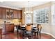 Cozy breakfast nook with a bay window, wooden table, and stylish chandelier at 6043 S Paris St, Greenwood Village, CO 80111