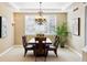 Dining room featuring a modern chandelier, a large window, and wood furniture at 6043 S Paris St, Greenwood Village, CO 80111