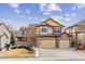 Charming two-story home featuring a three car garage, bay window, brick accents and a landscaped yard at 6043 S Paris St, Greenwood Village, CO 80111