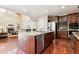 Spacious kitchen with a large island, stainless steel appliances, and dark wood cabinets at 6043 S Paris St, Greenwood Village, CO 80111