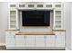 Living room cabinet with a butcher block countertop, white cabinets, and glass shelving at 6043 S Paris St, Greenwood Village, CO 80111