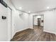 Large living room showcasing wood-look floors and a view into the kitchen at 6043 S Paris St, Greenwood Village, CO 80111