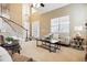 Bright living room featuring tall ceilings, a cozy couch, and large windows at 6043 S Paris St, Greenwood Village, CO 80111