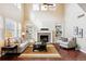 Bright living room with tall ceilings, fireplace, and comfortable seating area at 6043 S Paris St, Greenwood Village, CO 80111