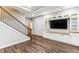 Living room view features wood-look floors, TV on the wall, and custom cabinetry at 6043 S Paris St, Greenwood Village, CO 80111