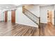 Spacious living room features wood-look floors, staircase, and sliding barn doors at 6043 S Paris St, Greenwood Village, CO 80111