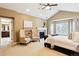 Relaxing main bedroom with a fireplace, vaulted ceilings, and a view of the en-suite bathroom at 6043 S Paris St, Greenwood Village, CO 80111