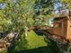 Manicured backyard featuring artifical turf, and mature shade trees with custom treehouse at 2235 Edgewood Dr, Boulder, CO 80304