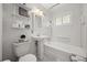 White bathroom featuring a pedestal sink, toilet, bathtub, and classic tile work at 2235 Edgewood Dr, Boulder, CO 80304