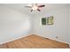 Clean bedroom with hardwood floors, a ceiling fan, white walls, and a window providing natural light at 2235 Edgewood Dr, Boulder, CO 80304