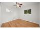 Inviting bedroom features hardwood floors, a ceiling fan, and two windows offering ample natural light at 2235 Edgewood Dr, Boulder, CO 80304