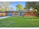 Charming red brick home with a well-manicured lawn and solar panels for energy savings at 2235 Edgewood Dr, Boulder, CO 80304