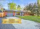 Charming red brick home with a well-manicured lawn and solar panels for energy savings at 2235 Edgewood Dr, Boulder, CO 80304