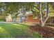 Charming red brick home with a well-manicured lawn and mature landscaping at 2235 Edgewood Dr, Boulder, CO 80304