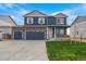 Charming two-story home boasts a three-car garage and manicured lawn at 13466 Valentia St, Thornton, CO 80602