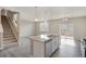 Modern kitchen featuring stainless steel appliances, a large center island with granite counters and a staircase at 13466 Valentia St, Thornton, CO 80602