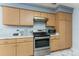 Stainless steel appliances and ample wood cabinets in kitchen at 19696 E 50Th Ave, Denver, CO 80249