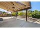 A spacious backyard with a covered patio and mature trees at 3870 S Ouray Way, Aurora, CO 80013