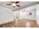 Spacious finished basement with wood-look flooring, and a ceiling fan at 3870 S Ouray Way, Aurora, CO 80013