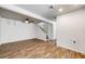 Open basement layout with stairs, window, ceiling fan, and vinyl flooring at 3870 S Ouray Way, Aurora, CO 80013