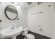 A well-lit bathroom featuring a stylish vanity and black and white tiling at 3870 S Ouray Way, Aurora, CO 80013