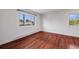 Bright bedroom features hardwood floors and a double-paned window with a pleasant view at 3870 S Ouray Way, Aurora, CO 80013