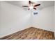 A cozy bedroom with wood flooring, a ceiling fan, and a window at 3870 S Ouray Way, Aurora, CO 80013