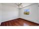 Bedroom features hardwood floors and a window overlooking a tree-lined street at 3870 S Ouray Way, Aurora, CO 80013