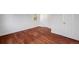 Clean bedroom featuring hardwood floors and a white door at 3870 S Ouray Way, Aurora, CO 80013