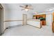 Open-concept dining area with tile floors, wood trim and cabinetry, leading into kitchen at 3870 S Ouray Way, Aurora, CO 80013