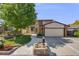 Charming two-story home with a lush front yard, brick accents, and a two-car garage at 3870 S Ouray Way, Aurora, CO 80013