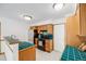 Bright kitchen with tile countertops, wood cabinets, updated appliances and white tile floors at 3870 S Ouray Way, Aurora, CO 80013
