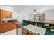 Well-lit kitchen boasting ample counter space, wood cabinets, and modern sink fixtures at 3870 S Ouray Way, Aurora, CO 80013