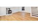 Bright living room featuring hardwood floors, a wood-burning stove, large windows, and a staircase at 3870 S Ouray Way, Aurora, CO 80013