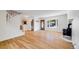 Bright living room featuring hardwood floors, a wood-burning stove, large windows, and a staircase at 3870 S Ouray Way, Aurora, CO 80013