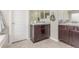 The bathroom features double vanities, dark wood cabinets, and a soaking tub at 129 N Irvington St, Aurora, CO 80018