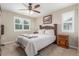 Cozy bedroom with a queen bed, ceiling fan, and two windows with views of the landscape at 129 N Irvington St, Aurora, CO 80018