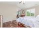 A well-lit bedroom featuring hardwood floors and a vaulted ceiling at 129 N Irvington St, Aurora, CO 80018