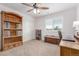 Bedroom featuring a wooden bookshelf, large window, and a storage bench at 129 N Irvington St, Aurora, CO 80018