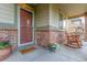 Inviting front porch with brick accents and charming rocking chairs at 129 N Irvington St, Aurora, CO 80018