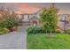 Charming exterior of a home with brick accents, a driveway, and lush green lawn at 129 N Irvington St, Aurora, CO 80018