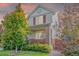 Exterior of a two-story home with red shutters, a brick accent, and manicured landscaping at 129 N Irvington St, Aurora, CO 80018