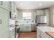 Bright kitchen with stainless steel appliances and a farmhouse sink at 129 N Irvington St, Aurora, CO 80018