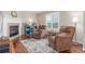 Sitting room with hardwood floors, stone fireplace, and natural lighting at 129 N Irvington St, Aurora, CO 80018